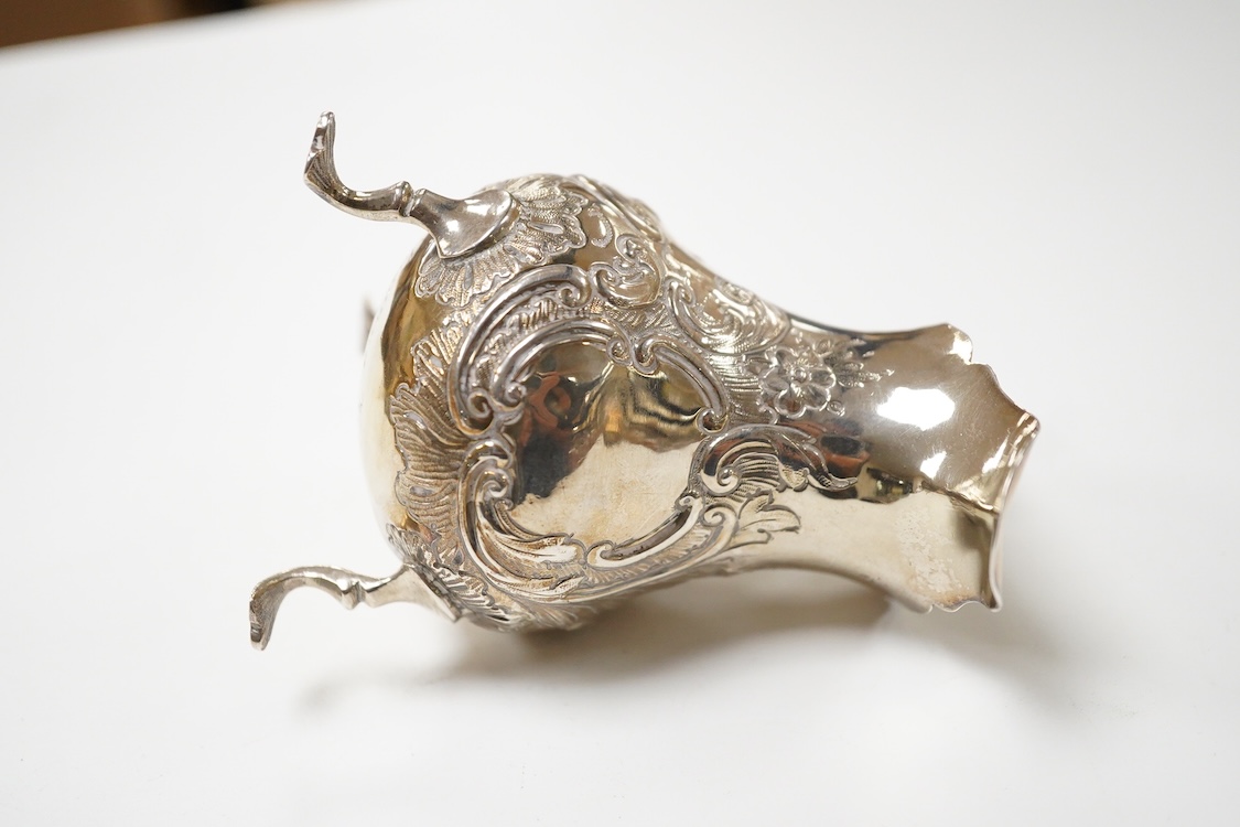 A George II small silver cream jug by David Mowden, London, 1754, of baluster form, with later embossed decoration, height 99mm, 79 grams.